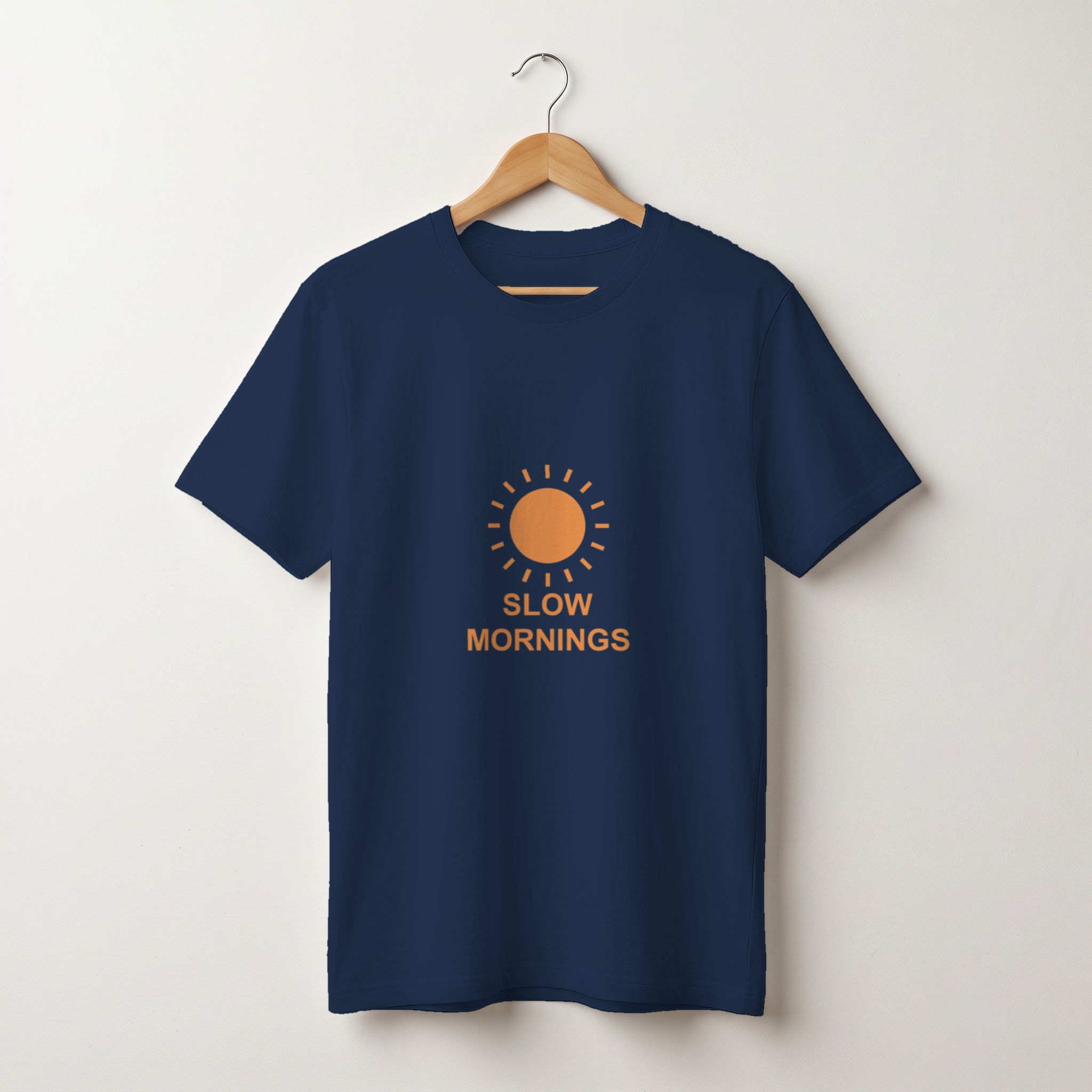 after: navy tee mockup on a wooden hanger with an orange sun print