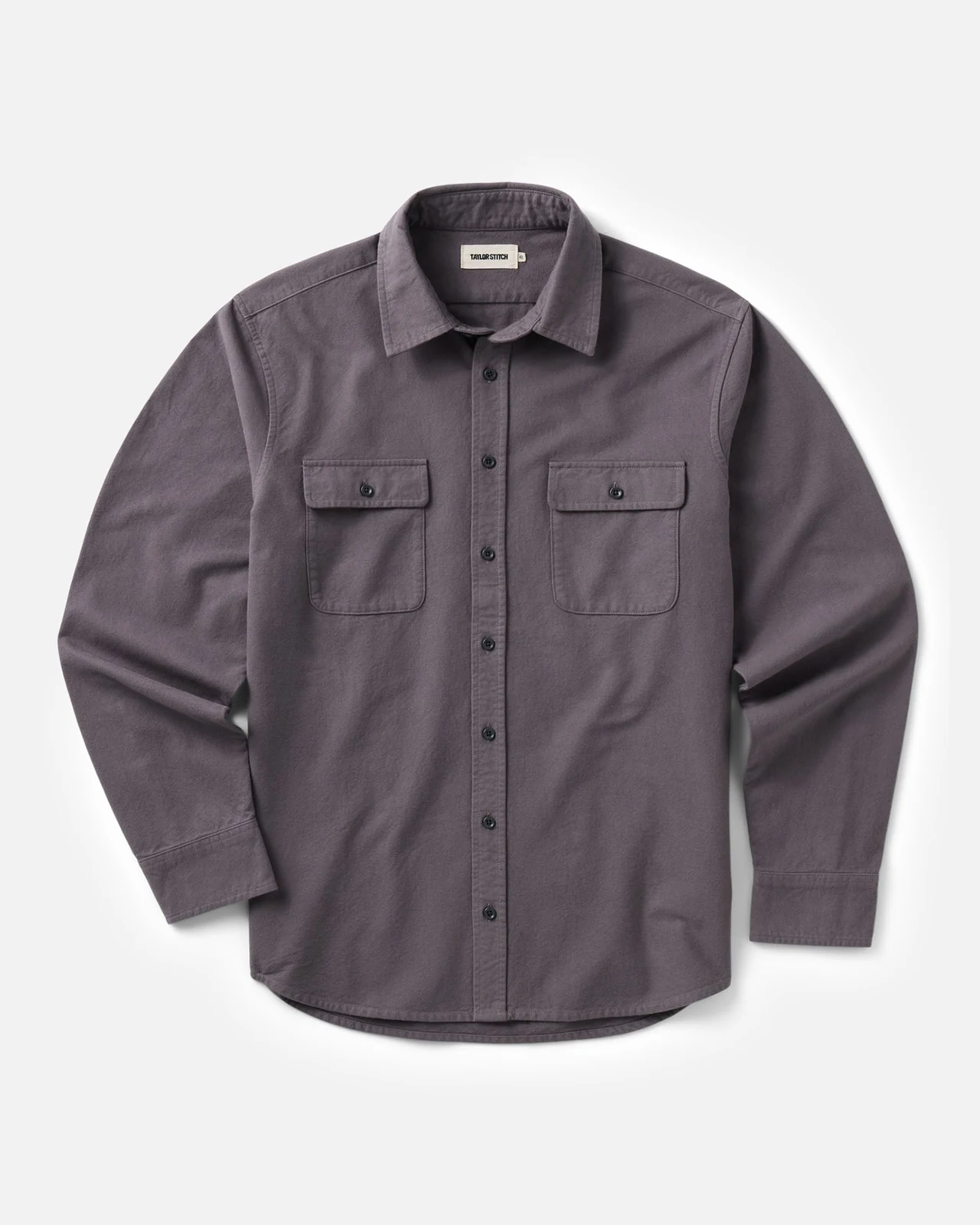 Flat lay of a gray-purple button-up shirt with two chest pockets