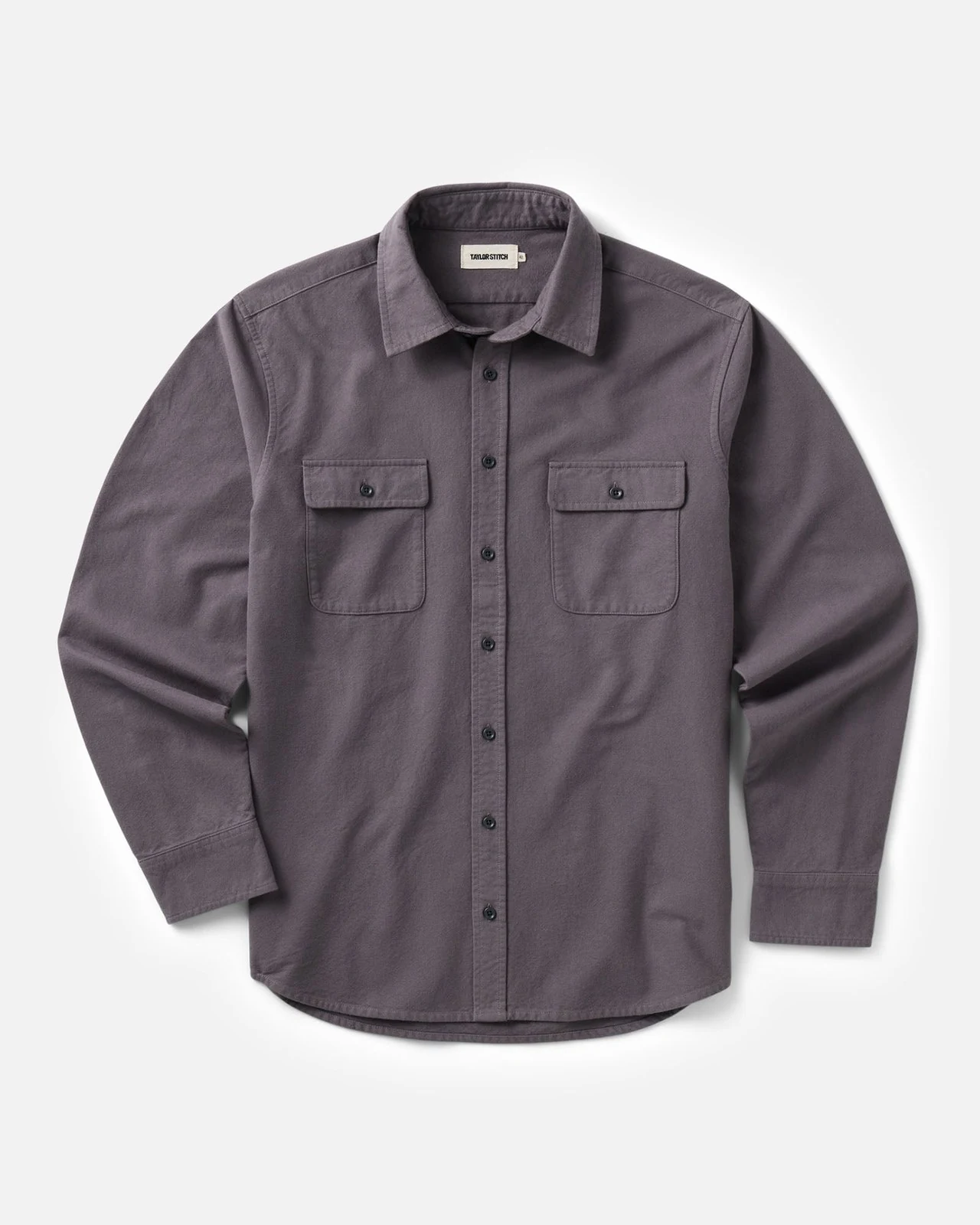 Flat lay of a gray-purple button-up shirt with two chest pockets
