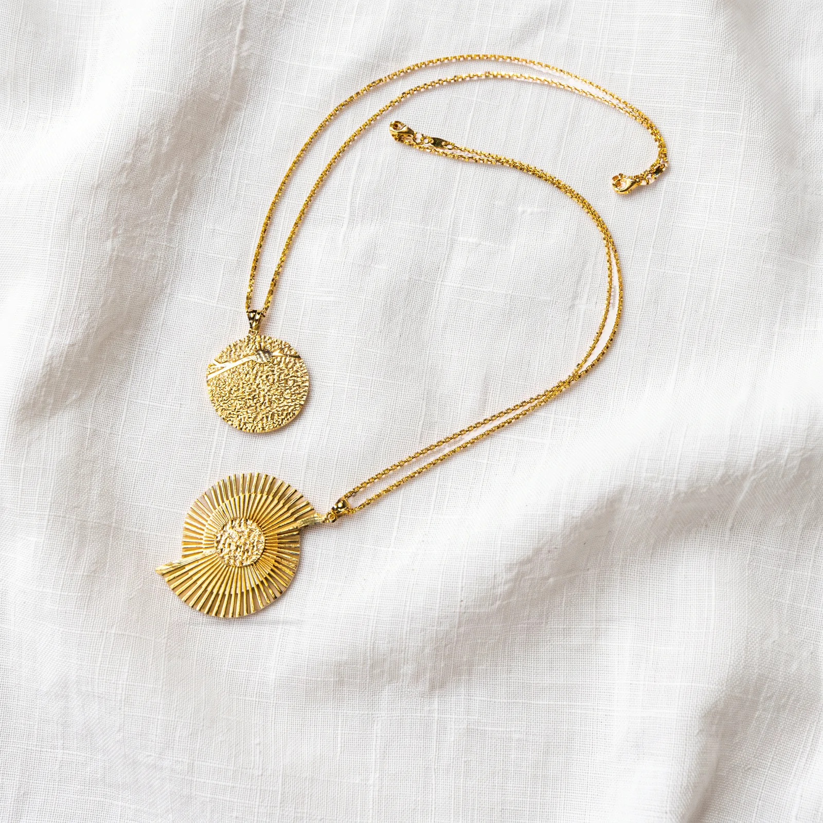 after: gold jewelry on softly lit linen