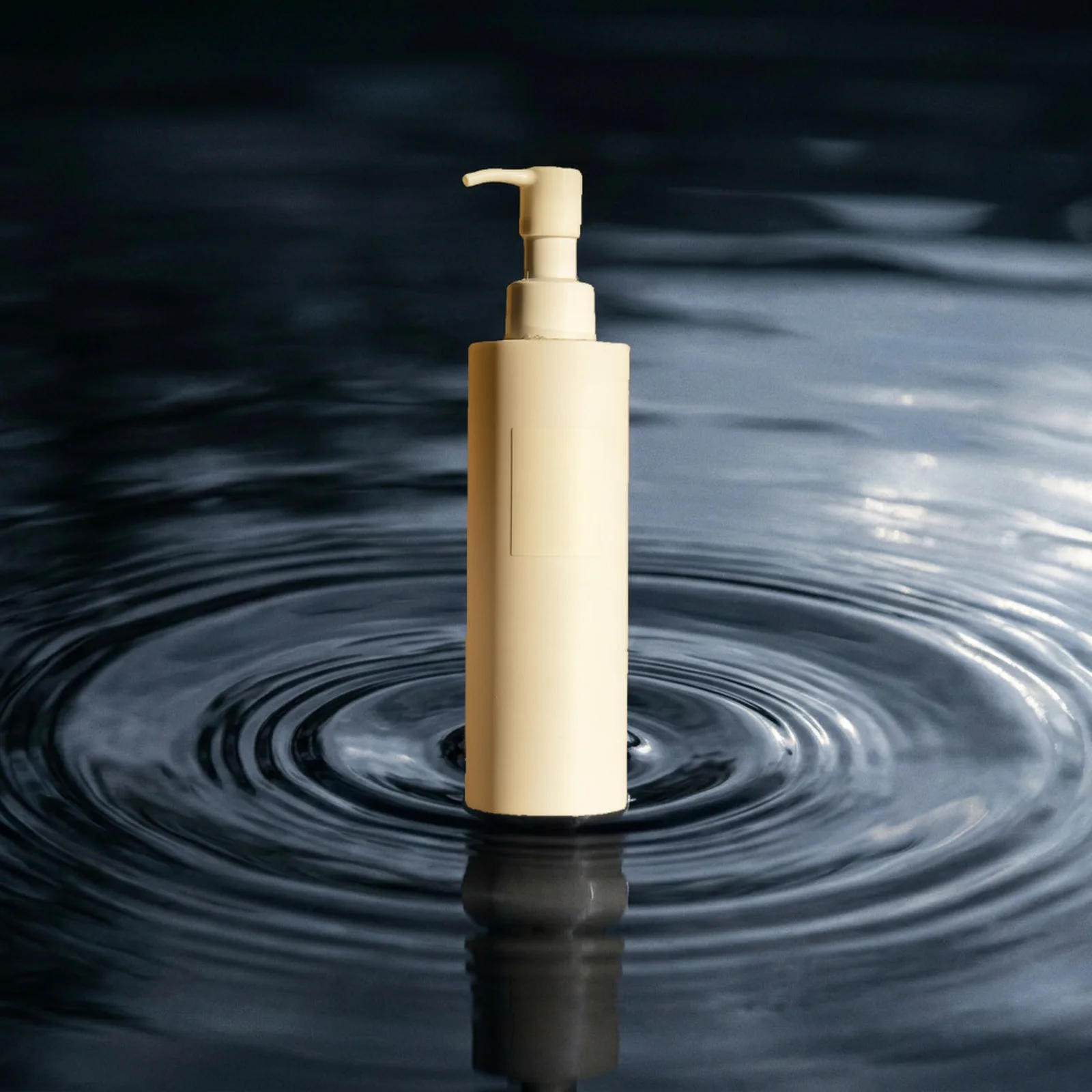 after: unbranded skincare bottle above dark rippling water