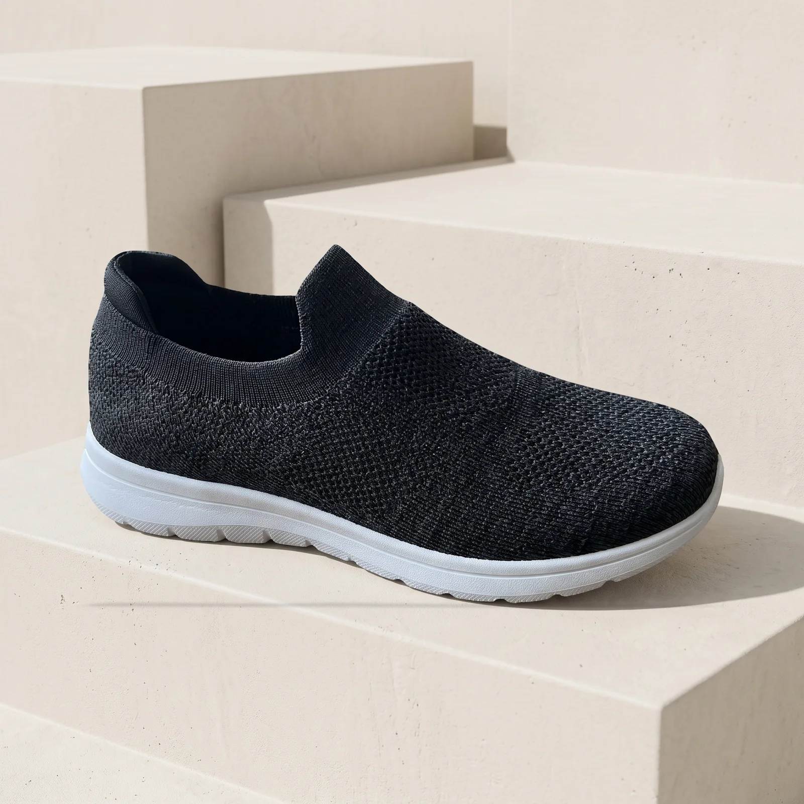 unbranded knit sneaker on light stone steps
