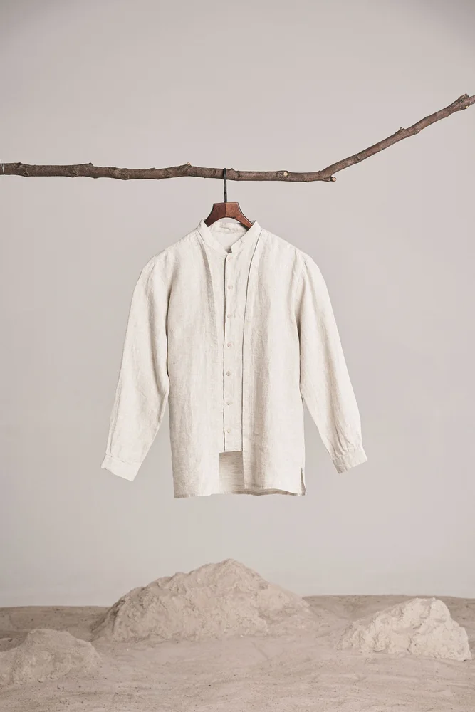 Beige linen shirt hanging from a branch in the existing lower-resolution sample
